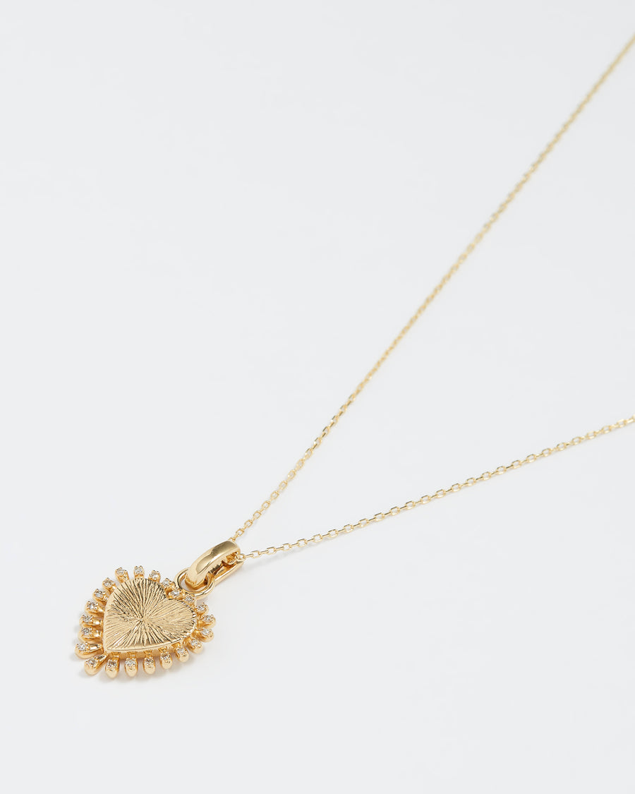 gold and diamond heart charm, product shot on a necklace chain