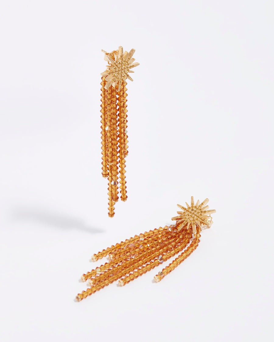 product shot of golden star earrings with sparkling crystal strands
