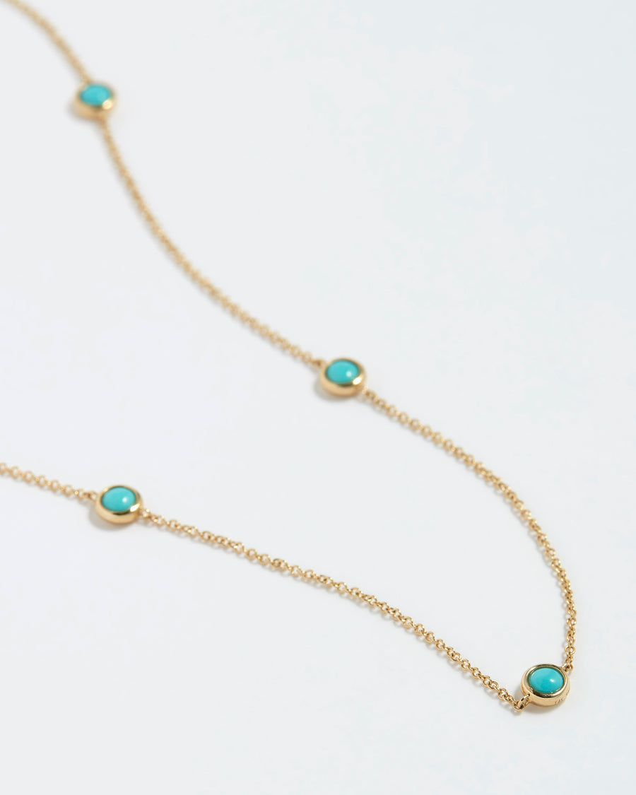 Soru Jewellery turquoise station and gold necklace product shot, close up detail.