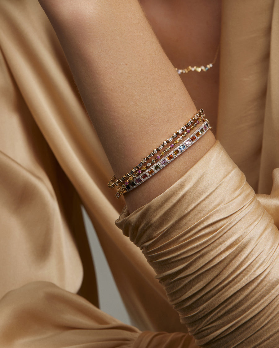 Soru Jewellery multi coloured sapphire and diamond bangles stacked on models arm 
