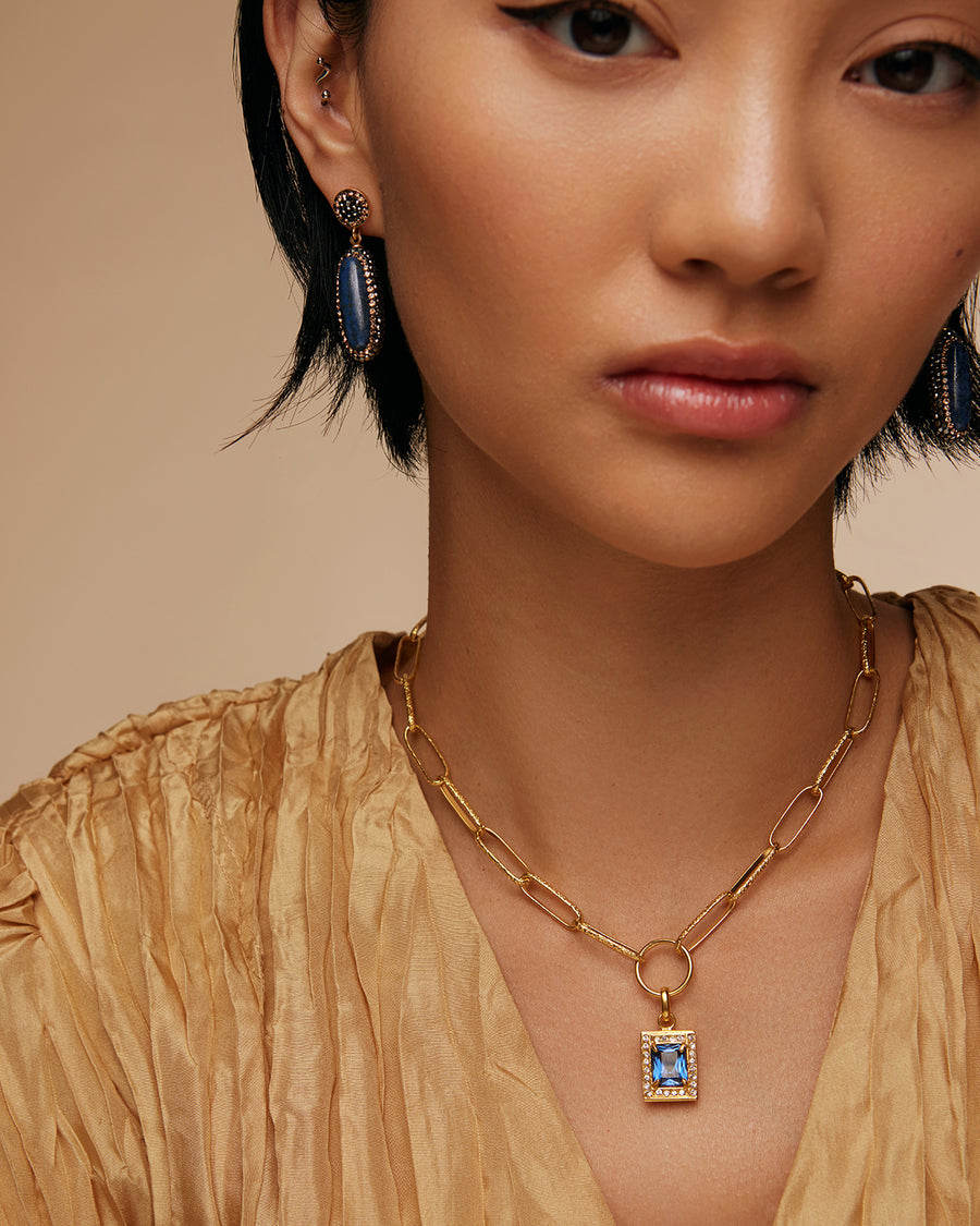 on the model shot of blue crystal square charm surrounded by clear crystals