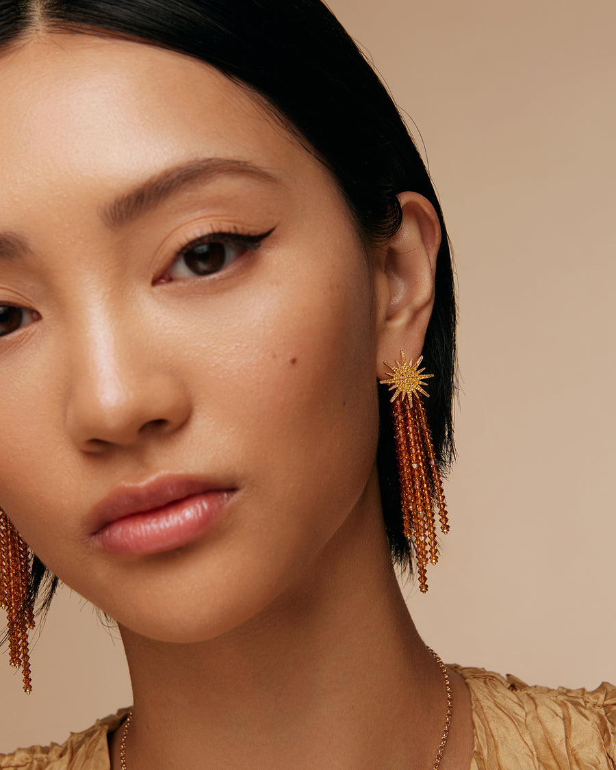 model shot of golden star earrings with sparkling crystal strands