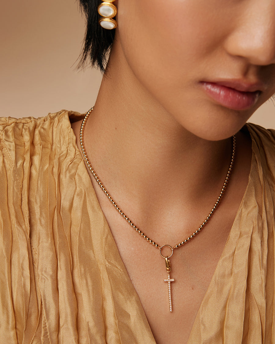 on model shot of long line cross detachable charm embellished with crystals on a chain