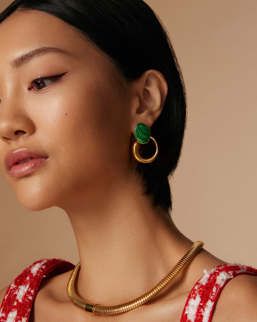 model shot of green oval malachite earrings with a yellow gold hoop and snake chain necklace