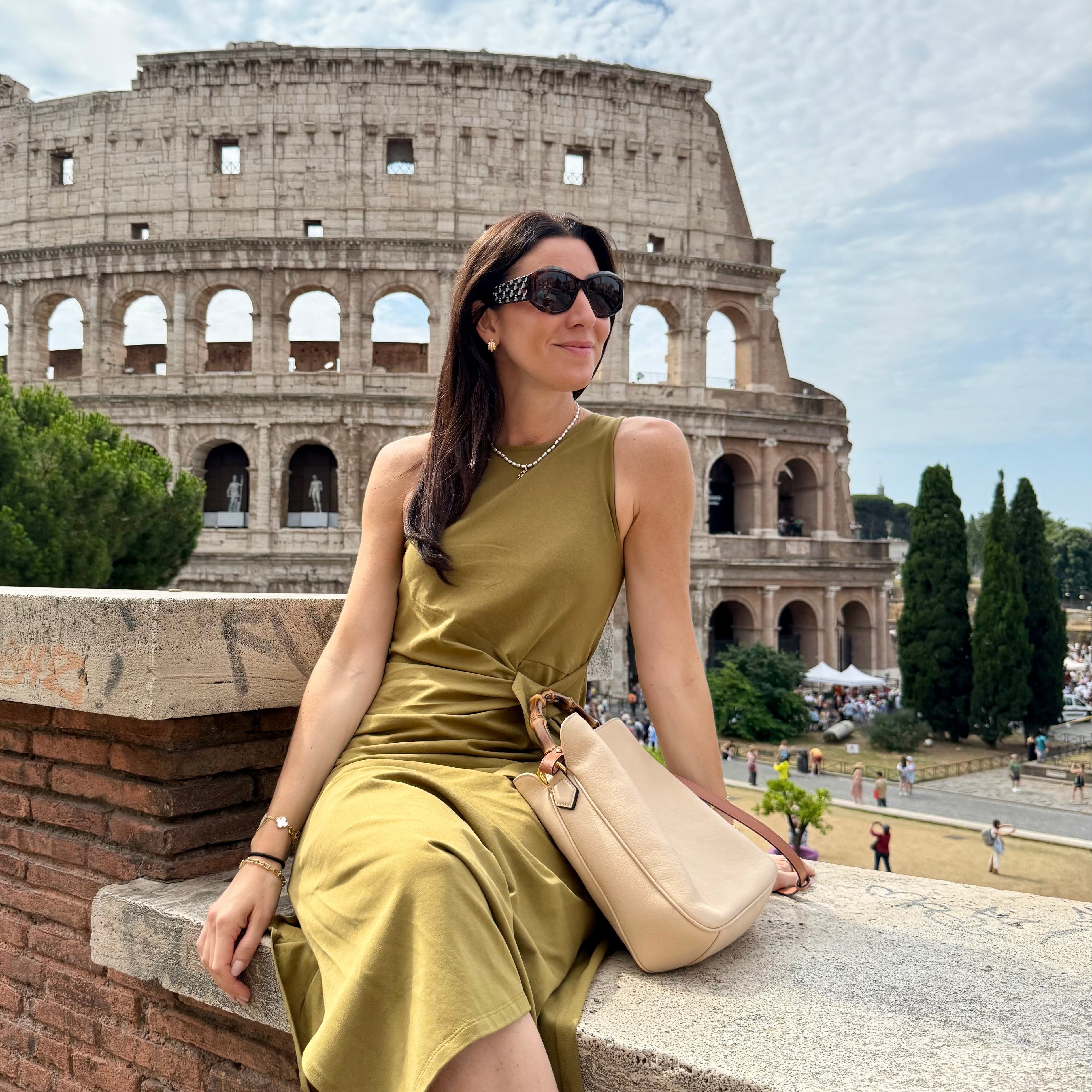 Marianna sitting on a wall in front of the Colosseum
