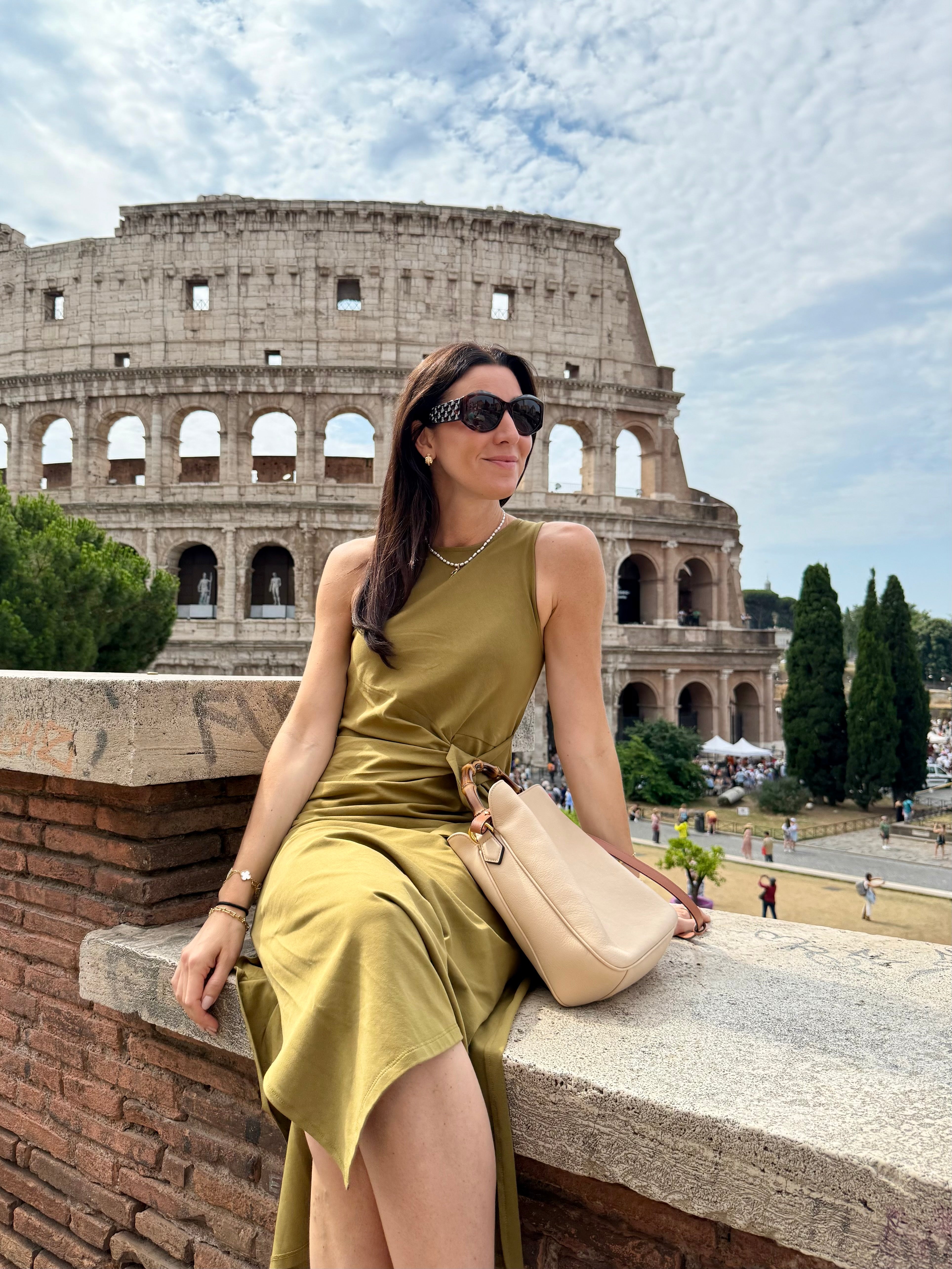 Marianna sitting on a wall in front of the Colosseum
