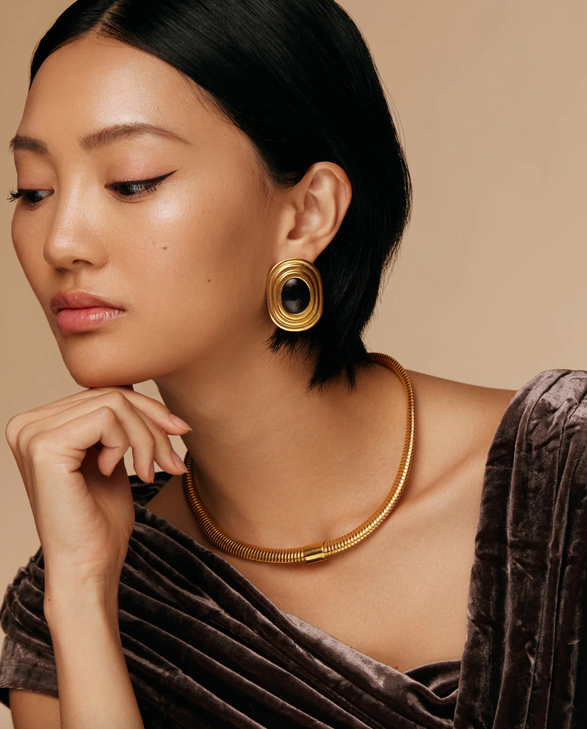 Silver star design earrings worn by smiling model