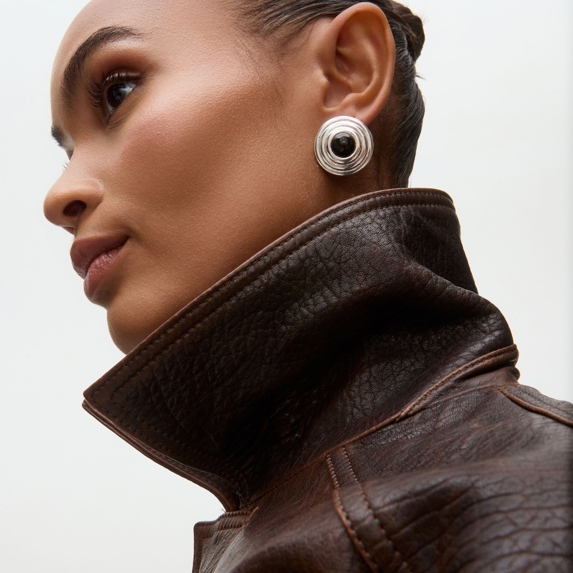 Sillver and onyx round oversized stud earrings on model 
