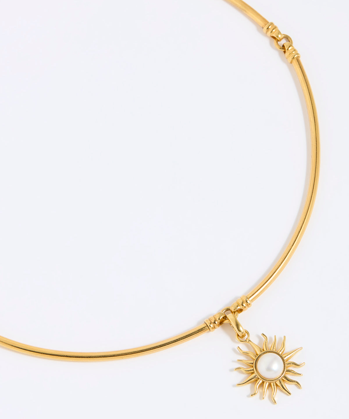 Gold choker with a sun-shaped charm on a white background
