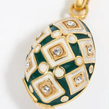 egg shaped Decorative charm pendant with green and gold design on a white background