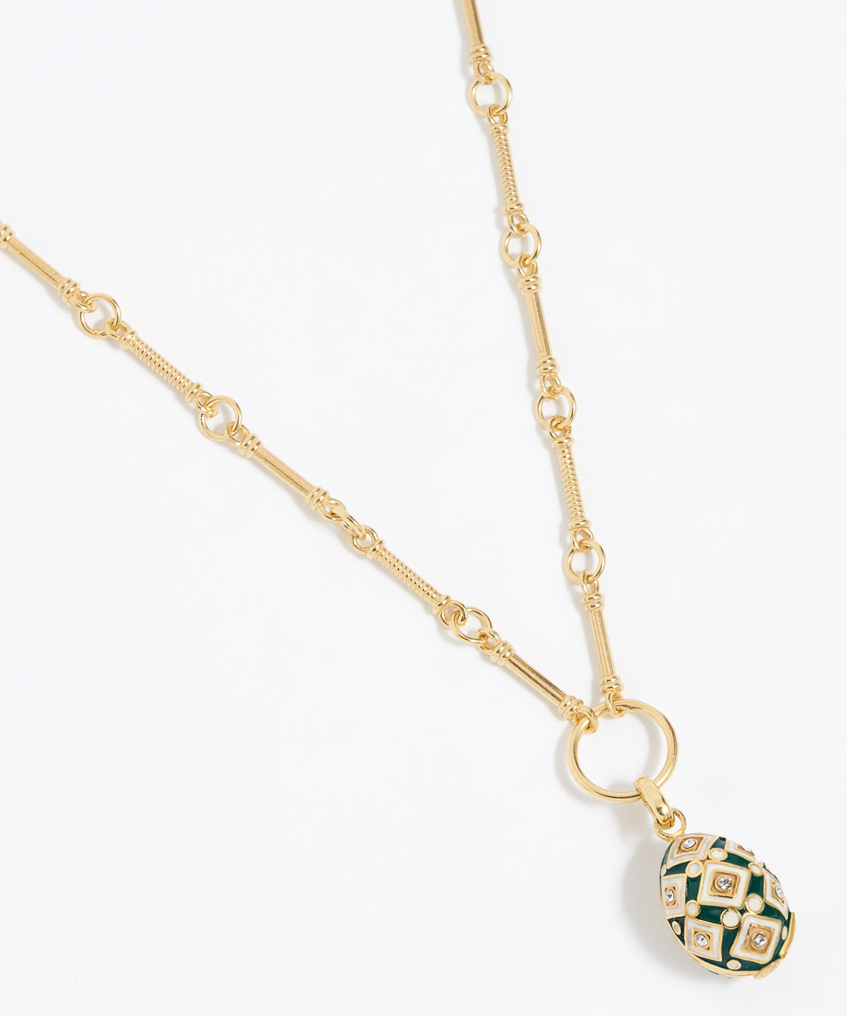 egg shaped Decorative charm pendant with green and gold design attached to gold link chain,  on a white background