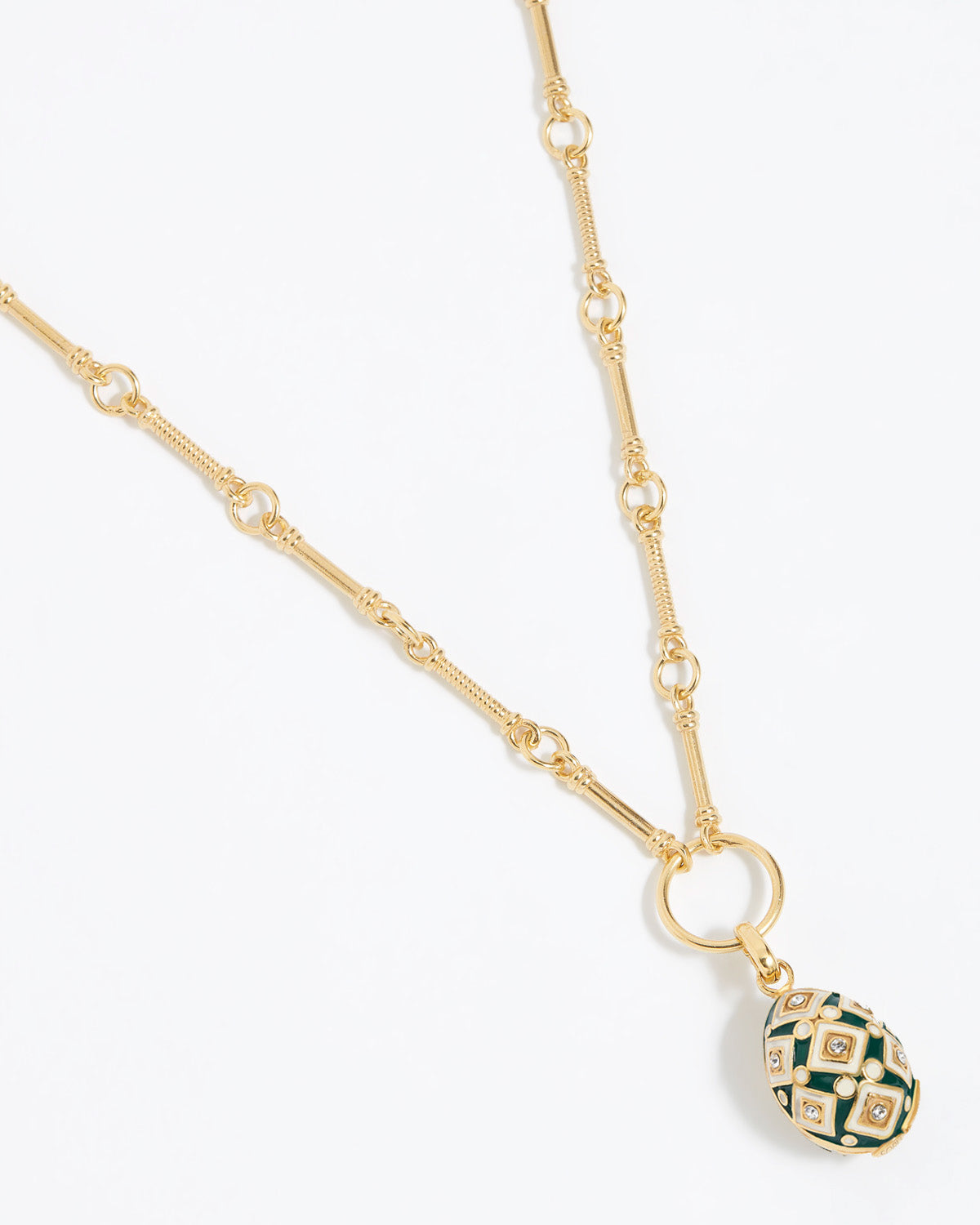 egg shaped Decorative charm pendant with green and gold design attached to gold link chain,  on a white background