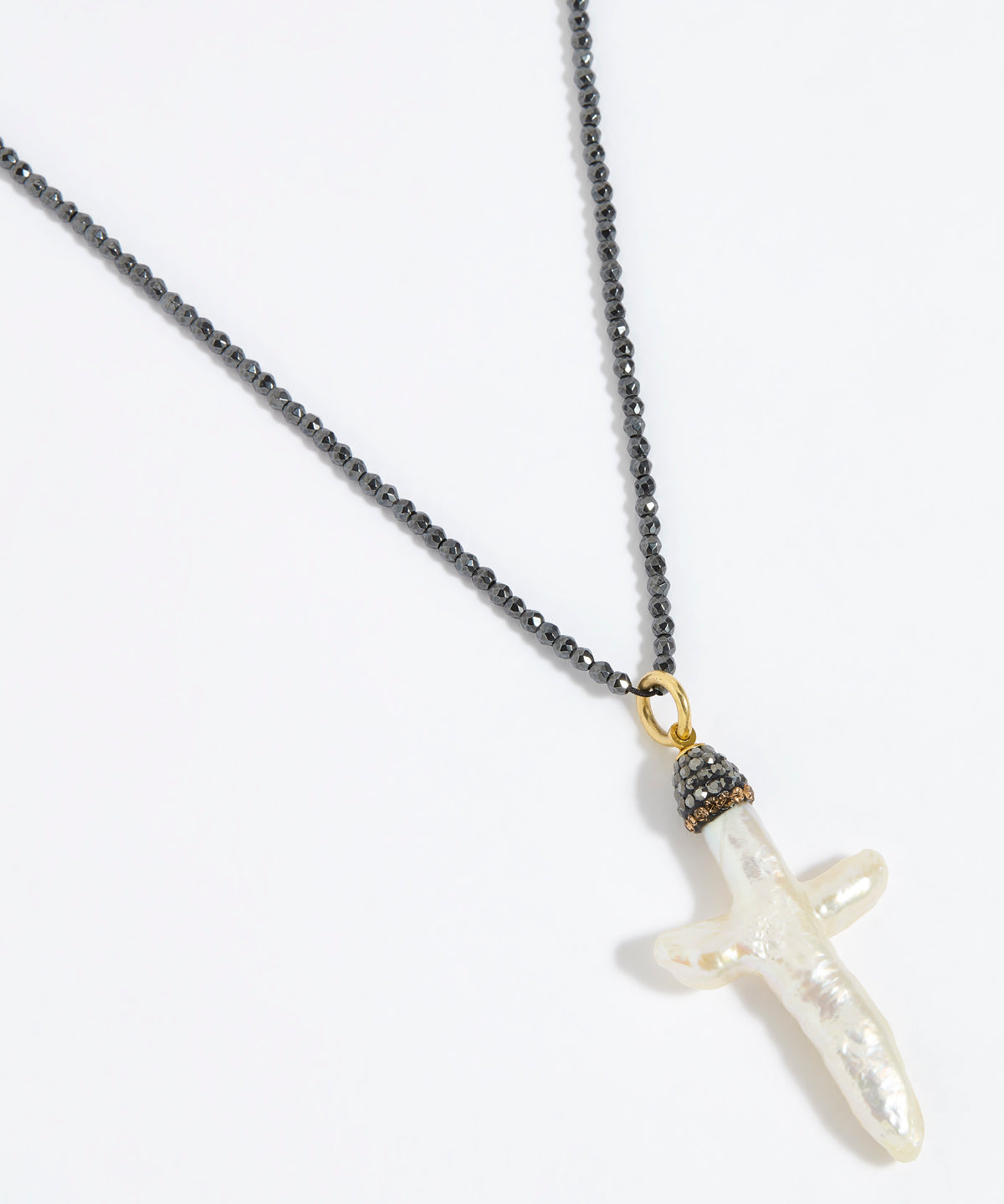 Pewter coloured beaded necklace with a white Baroque Pearl Cross pendant on a white background