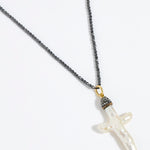 Pewter coloured beaded necklace with a white Baroque Pearl Cross pendant on a white background
