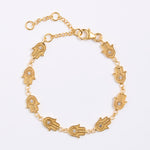 product shot on white background of a hamsa hand gold bracelet
