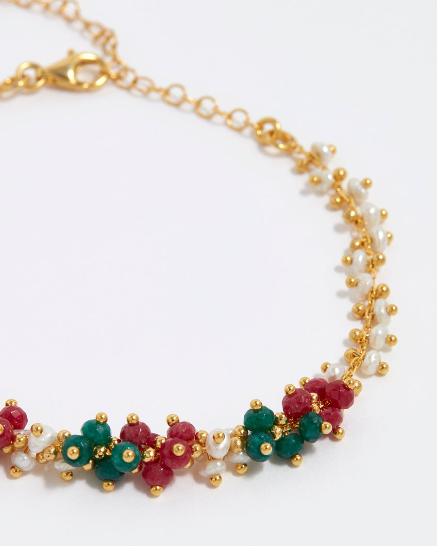 close up shot of soru jewellery gold plated silver bracelet with green, and red jade gemstones and mini pearls
