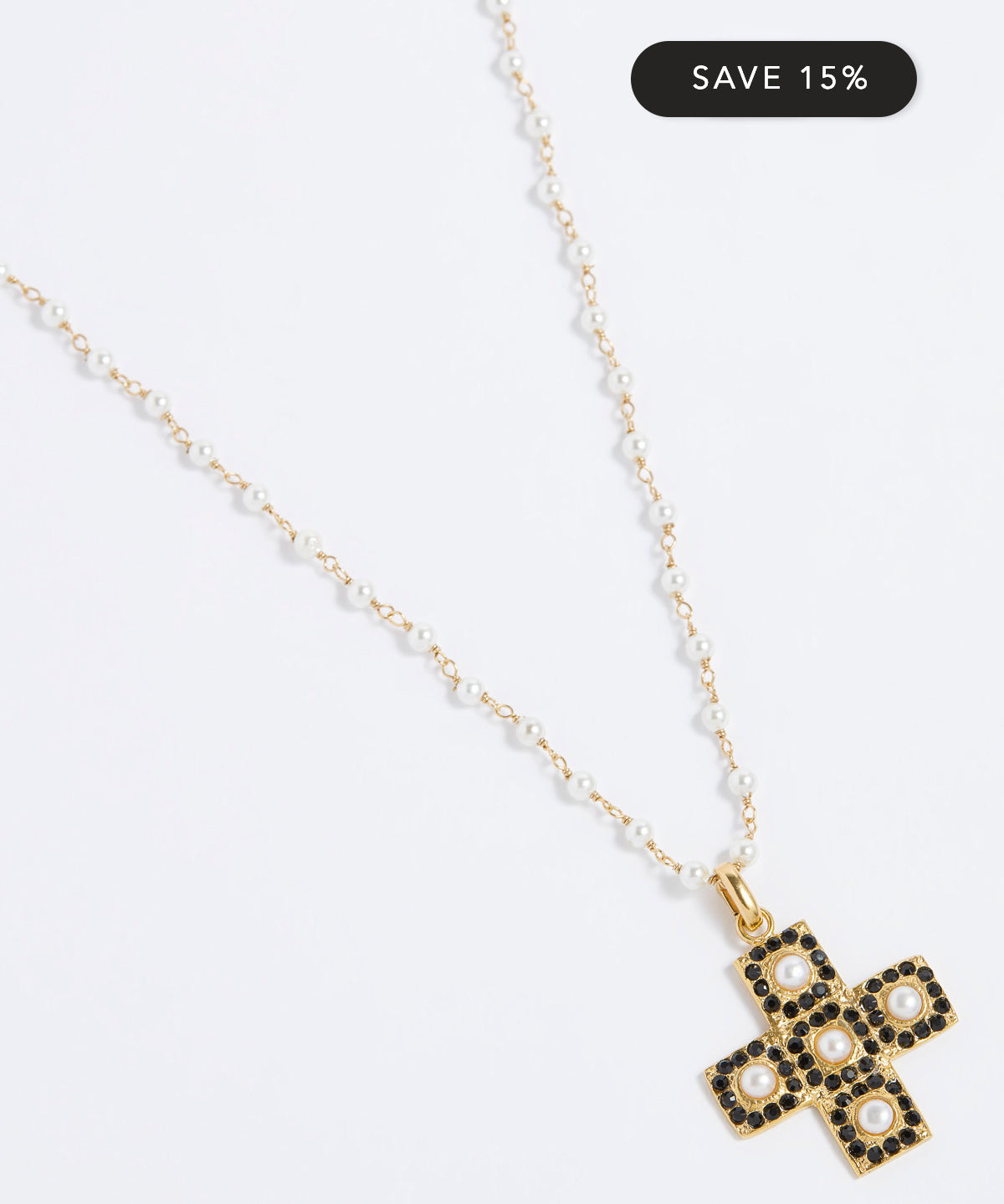 Gold necklace with a cross pendant on a white background, featuring a 'Save 15%' label.