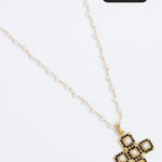 Gold necklace with a cross pendant on a white background, featuring a 'Save 15%' label.