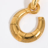 Gold coloured horse shoe pendant on a white background