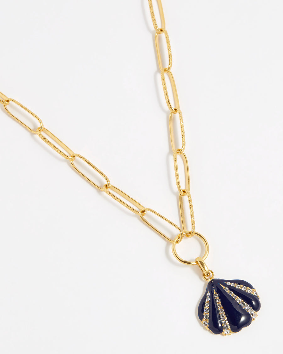 product shot of navy blue enamel and crystal encrusted shell shaped charm on chain