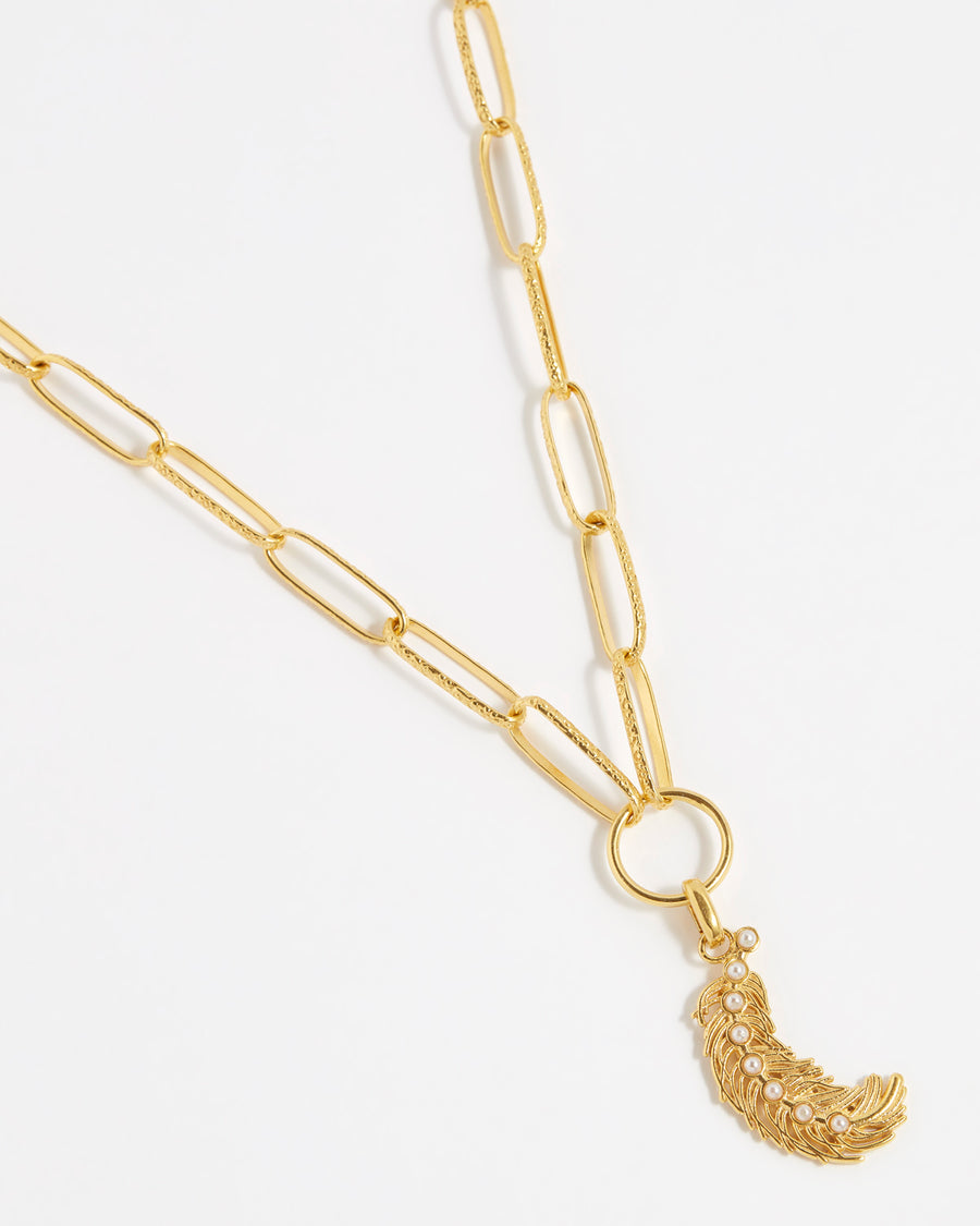 product shot of gold plated silver feather charm with pearls down the centre on the chain