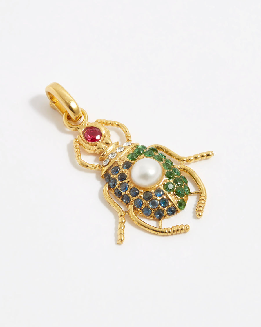 product shot of scarab beetle charm encrusted with red, bue and green crystals and one pearl on the back