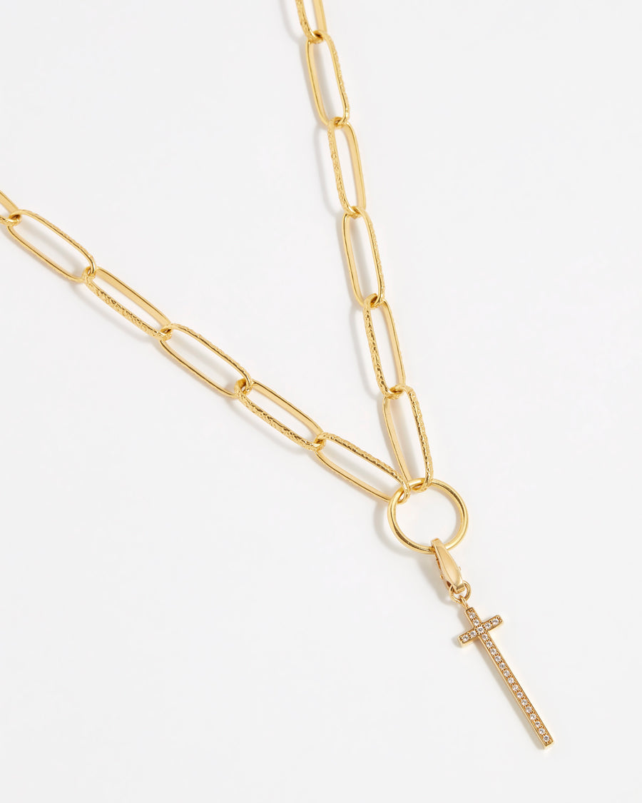 product shot of long line cross detachable charm embellished with crystals on a chain