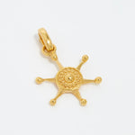 image shot of gold ships wheel charm on a white background