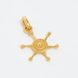 image shot of gold ships wheel charm on a white background