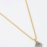 overhead product shot of Crystal Embellished Silver Shell Charm on a chain with a white background