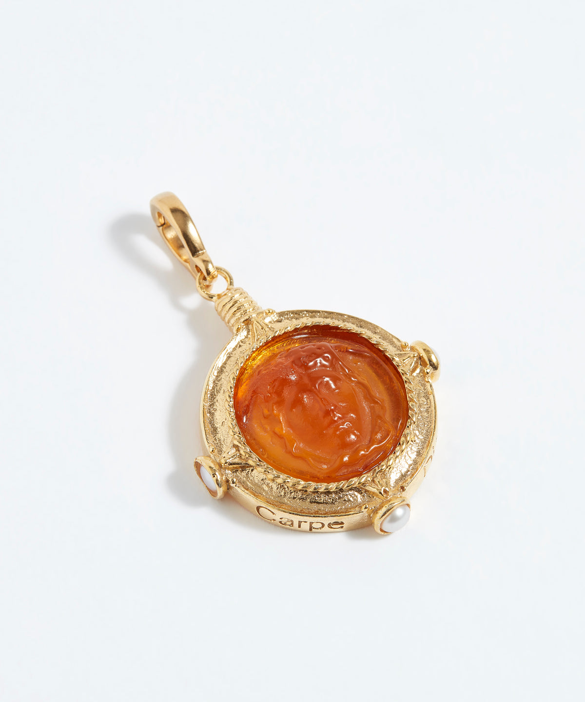 Gold pendant with a central Topaz-colored stone on a white background