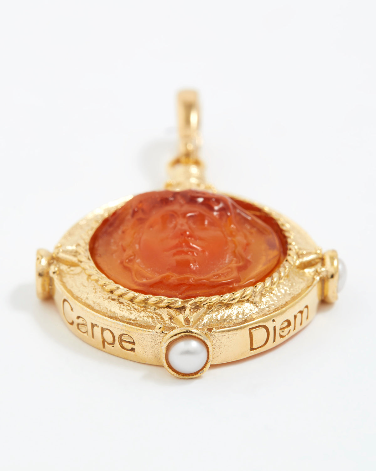 Gold pendant with a topaz stone and pearl on a white background