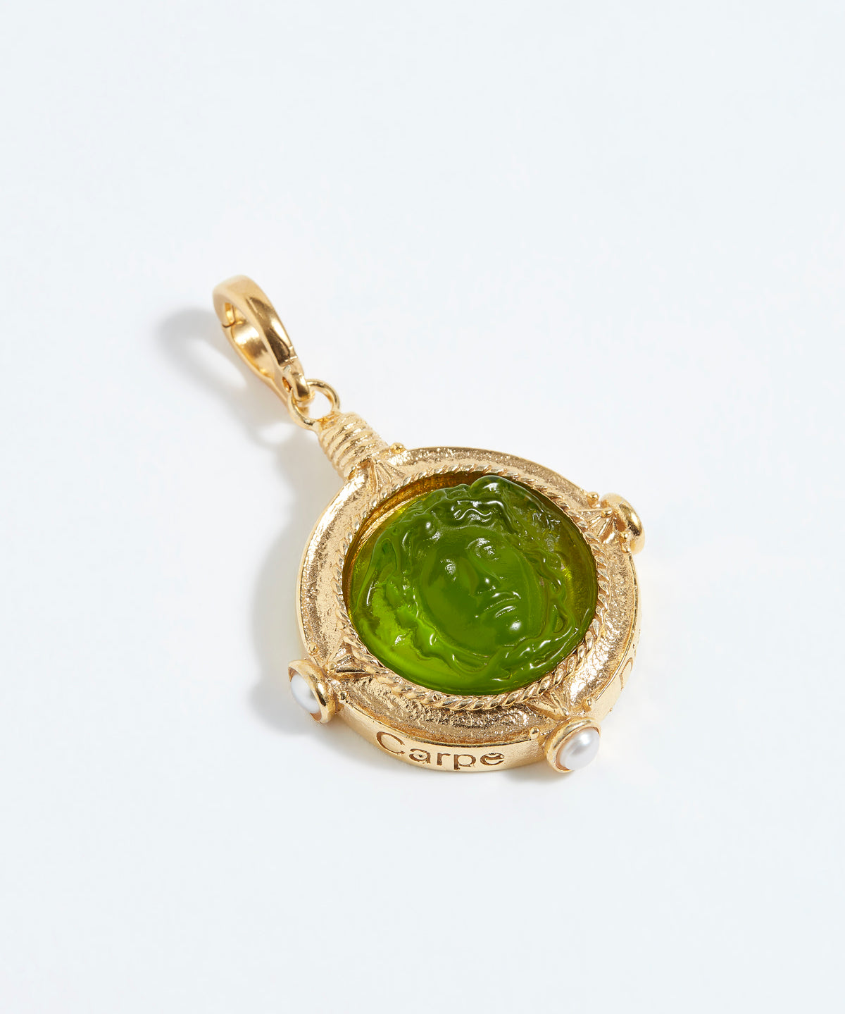 Gold pendant with green gemstone on a white background