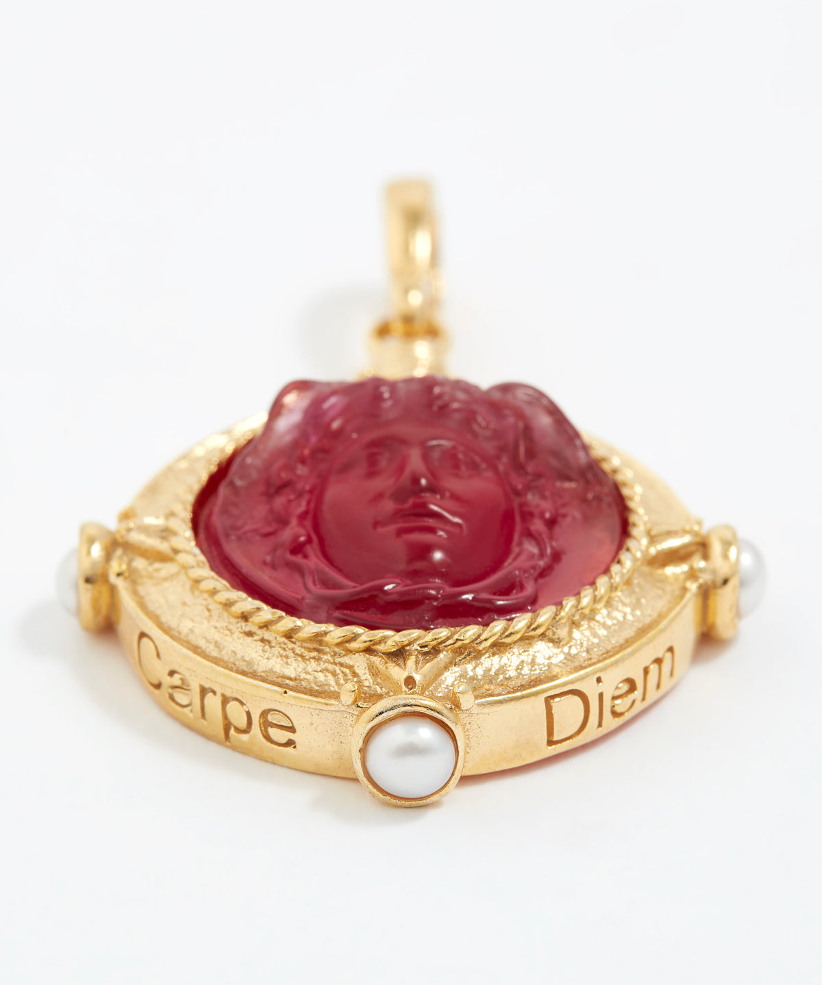 Gold pendant with red stone and pearl on a white background