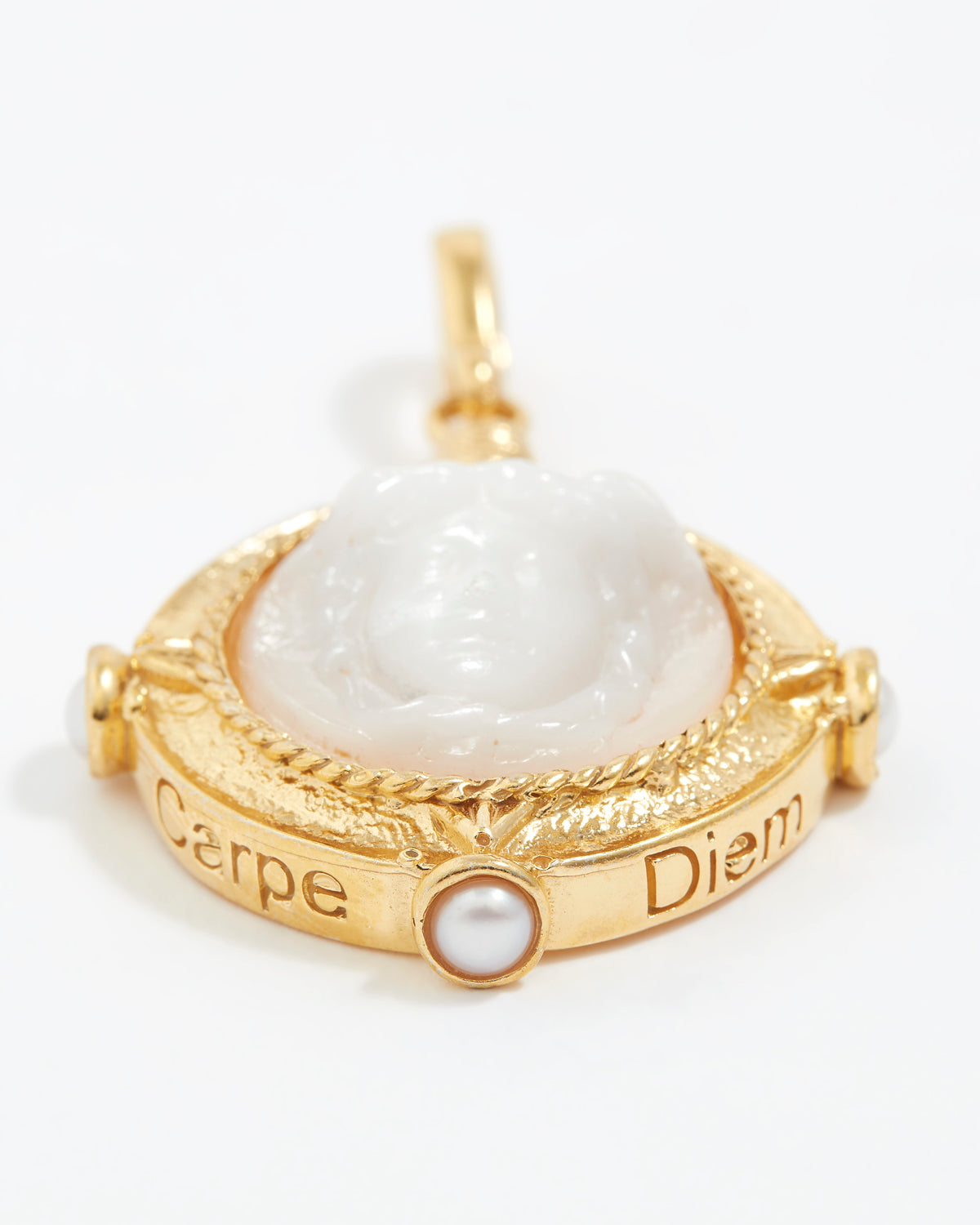 Gold pendant with a white stone and 'Carpe Diem' engraving on a white background