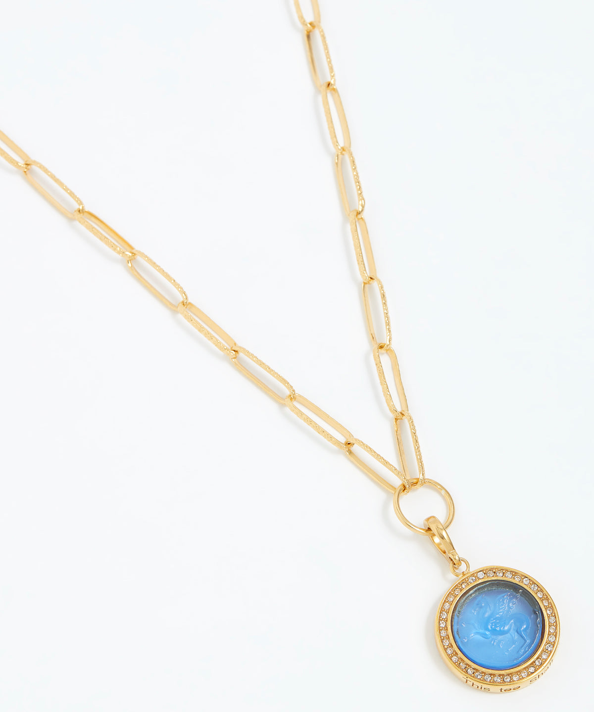 Gold chain necklace with a blue pendant on a white background