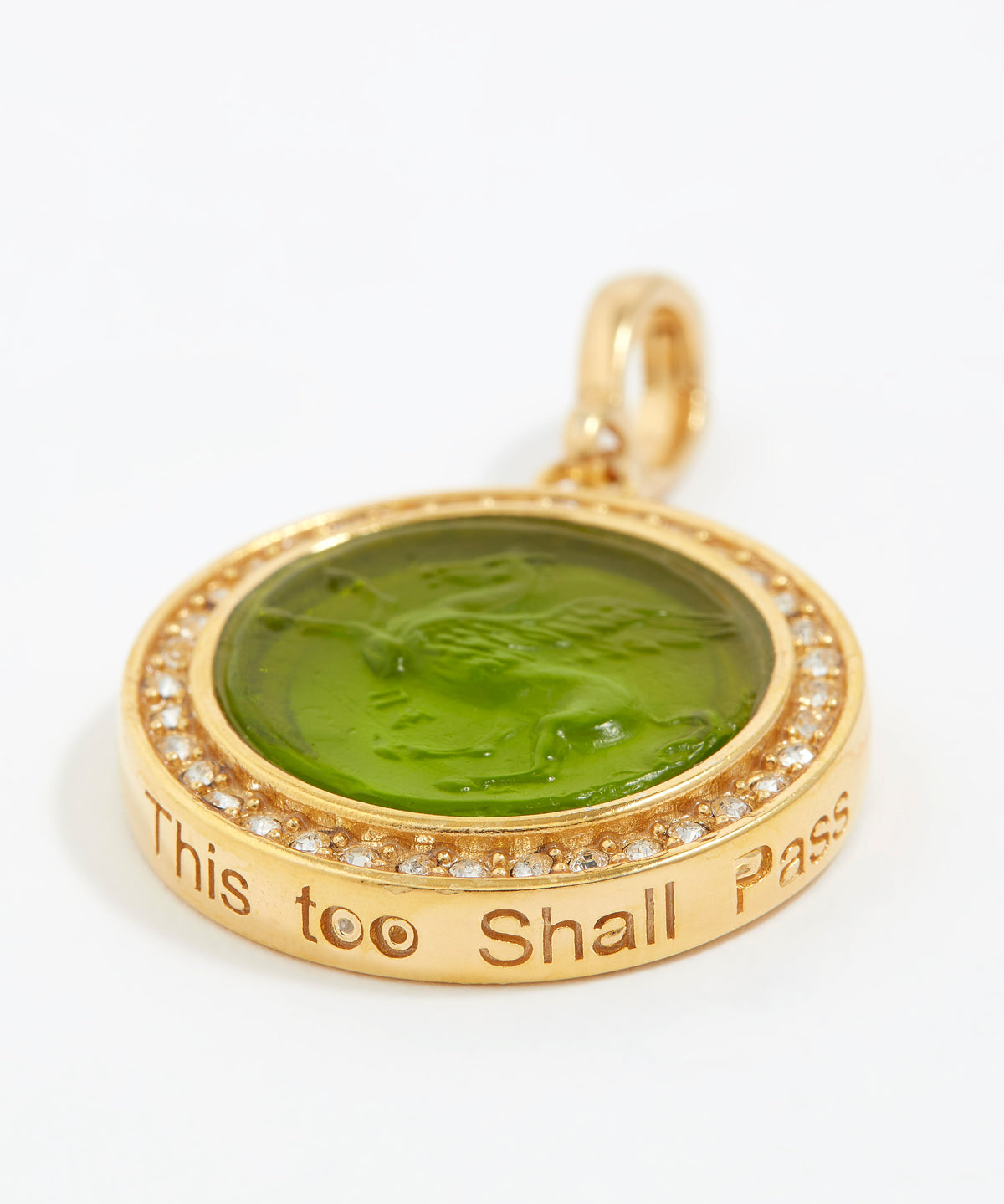 Gold pendant with green stone and engraved text "this too shall pass"  on a white background