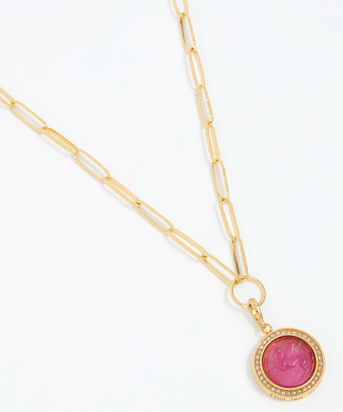 Gold necklace with a pink gemstone pendant on a white background