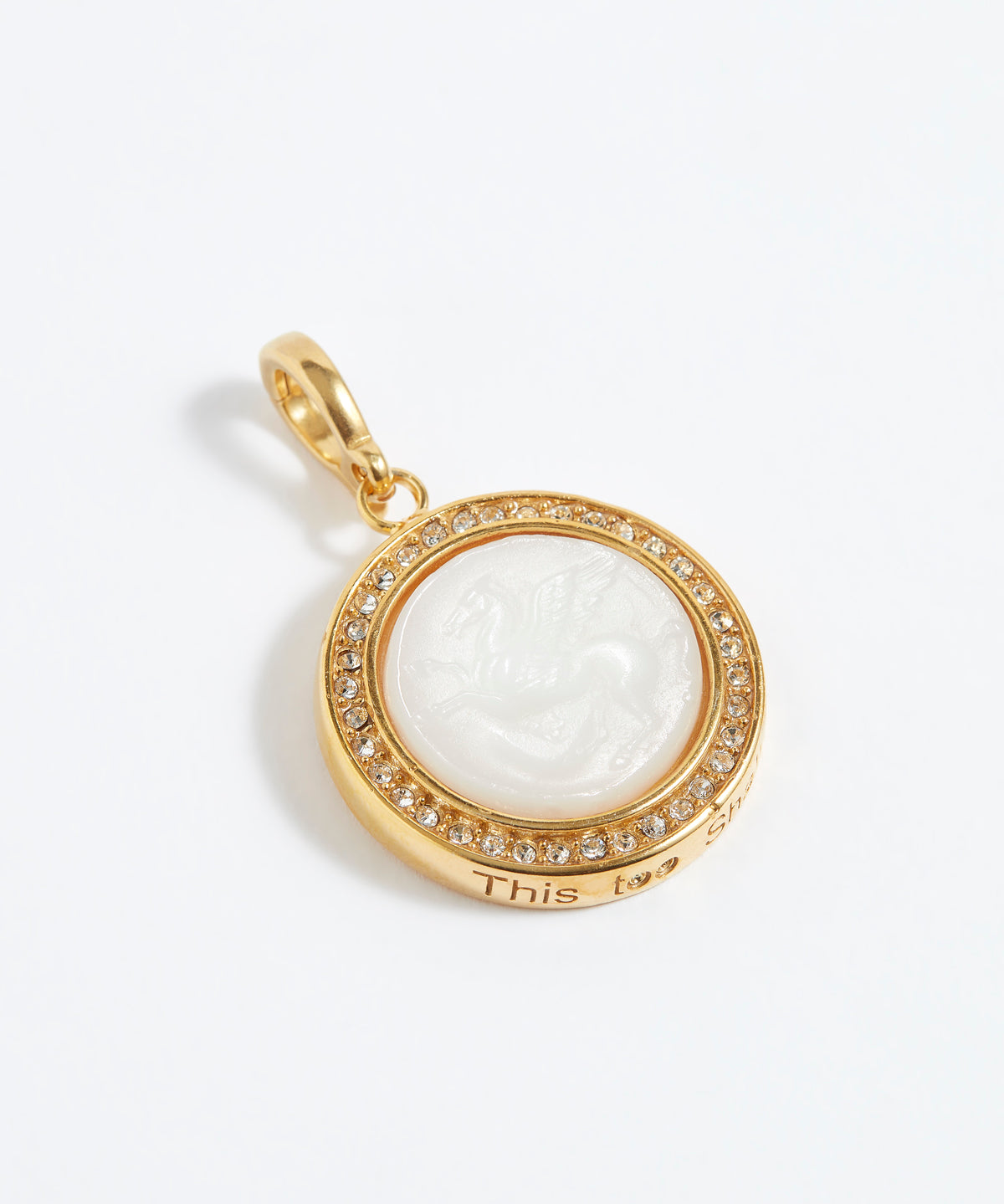 Gold pendant with a white central design on a white background