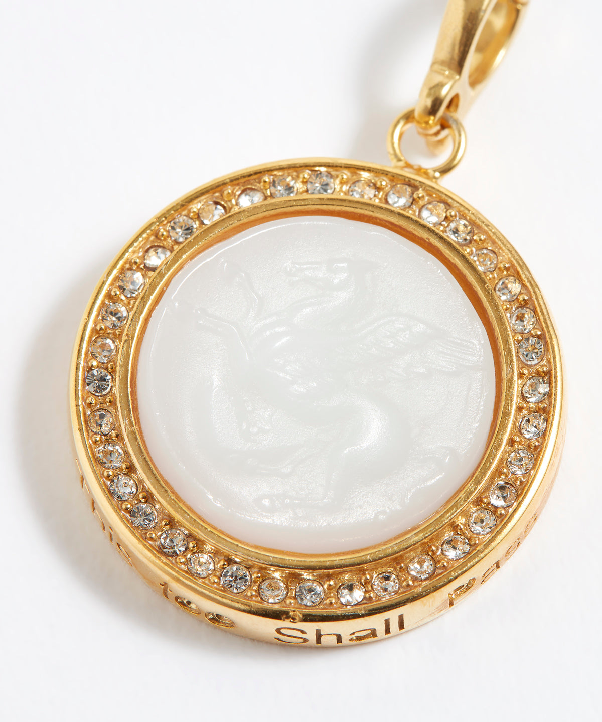 Gold pendant with a white central stone on a white background