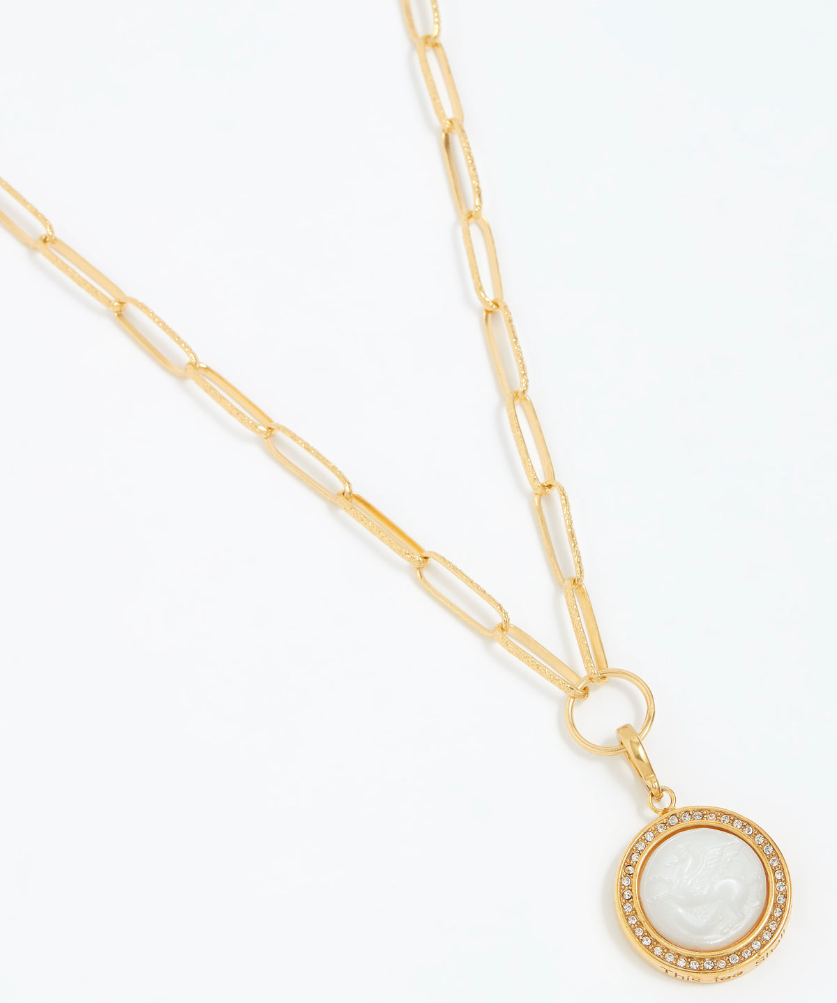 Gold necklace with a circular pendant on a white background