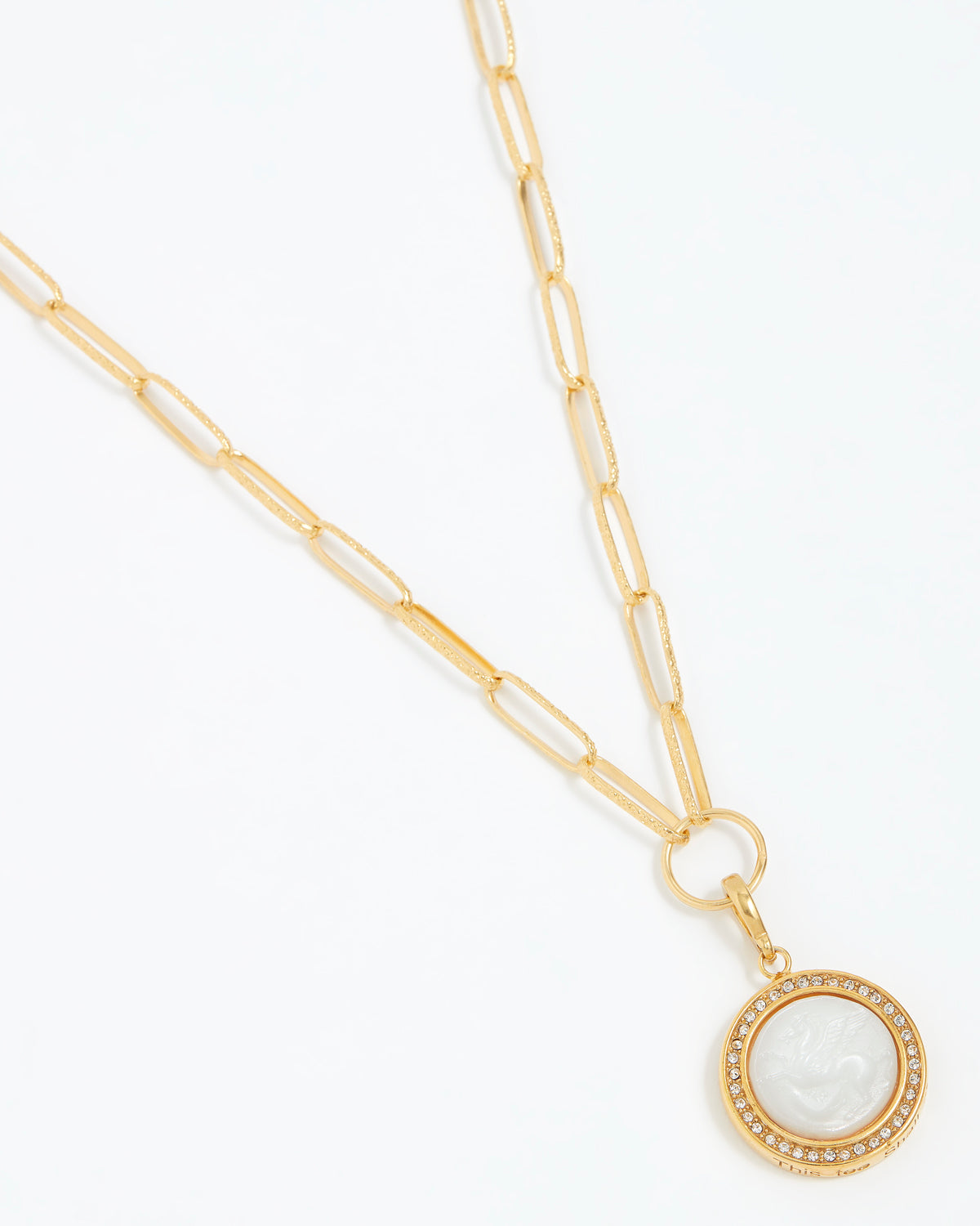 Gold necklace with a circular pendant on a white background
