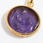 Purple stone pendant engraved with engraved angel numbers 1111 with gold setting on a white background