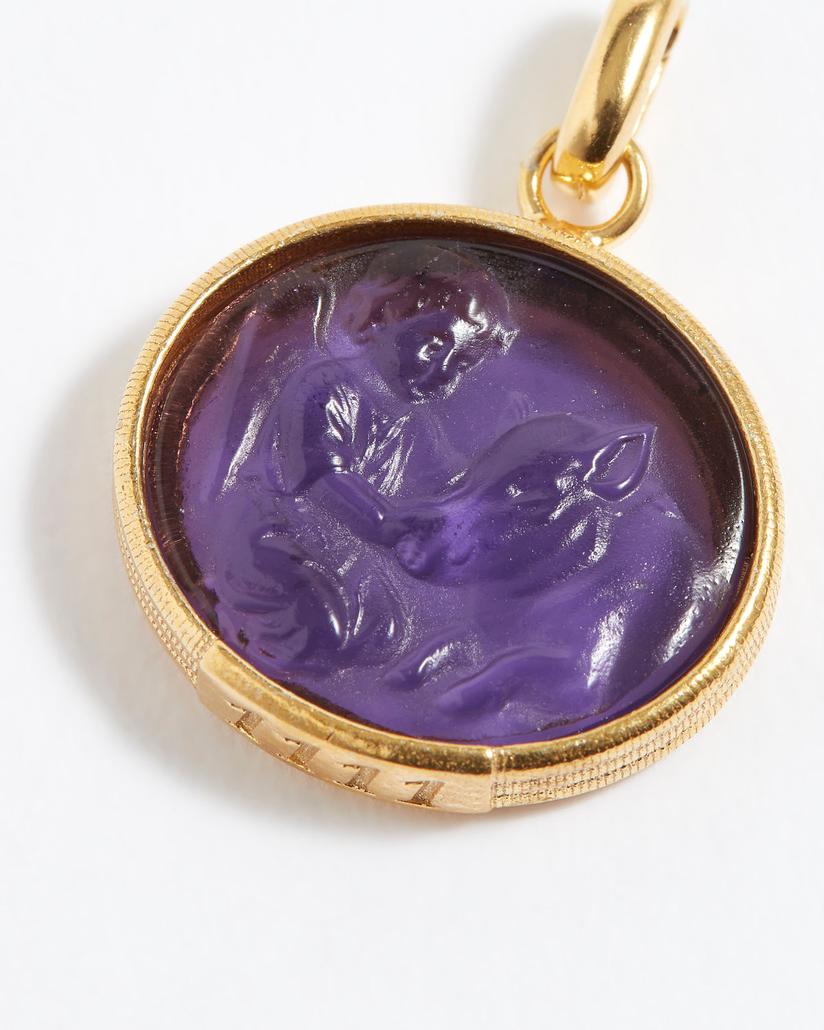 Purple stone pendant engraved with engraved angel numbers 1111 with gold setting on a white background