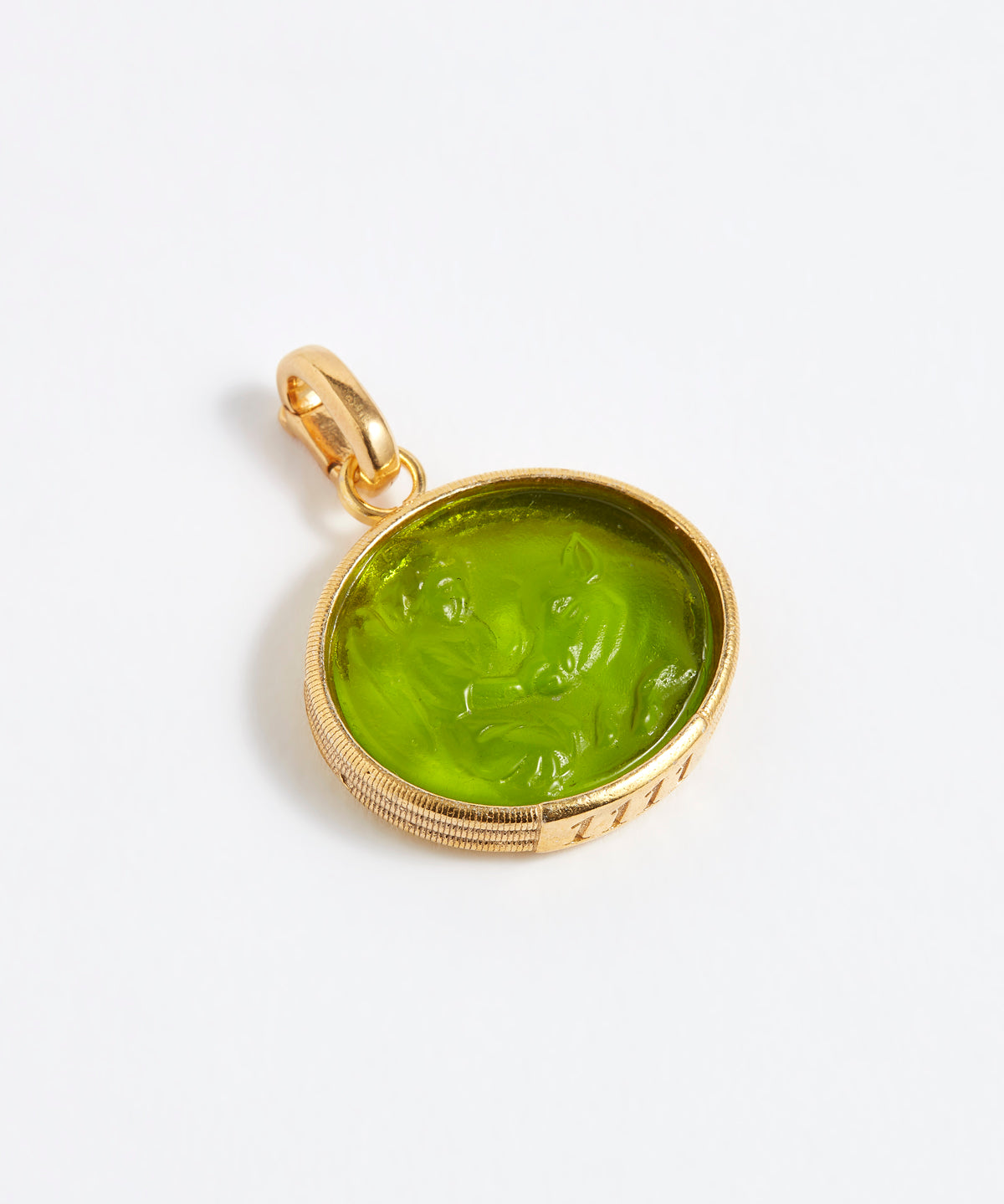 Gold pendant with a green stone on a white background