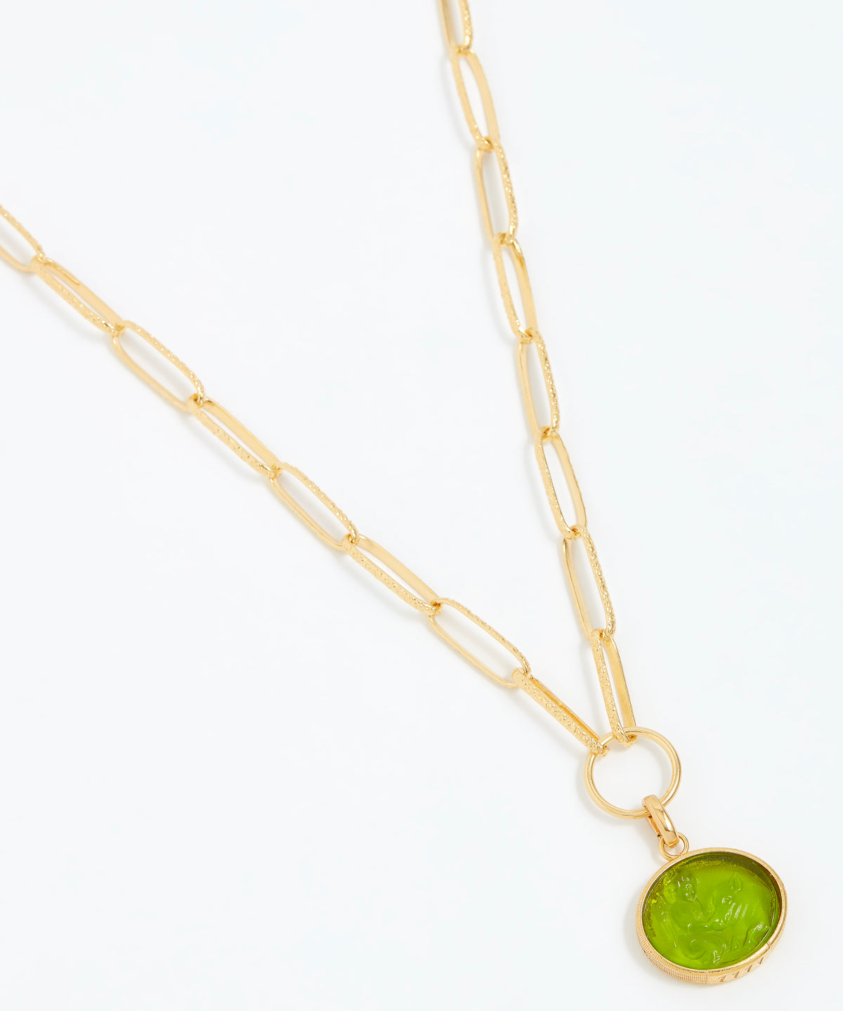Gold necklace with a green pendant on a white background