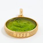Gold pendant with green stone and engraved angel number '1111' on a white background