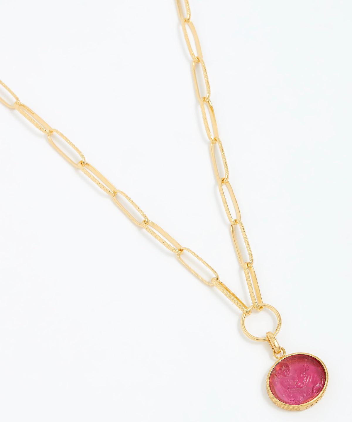 Gold necklace with a pink pendant on a white background