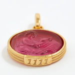 Gold pendant with a red stone and engraved angel numbers 1111 on a white background