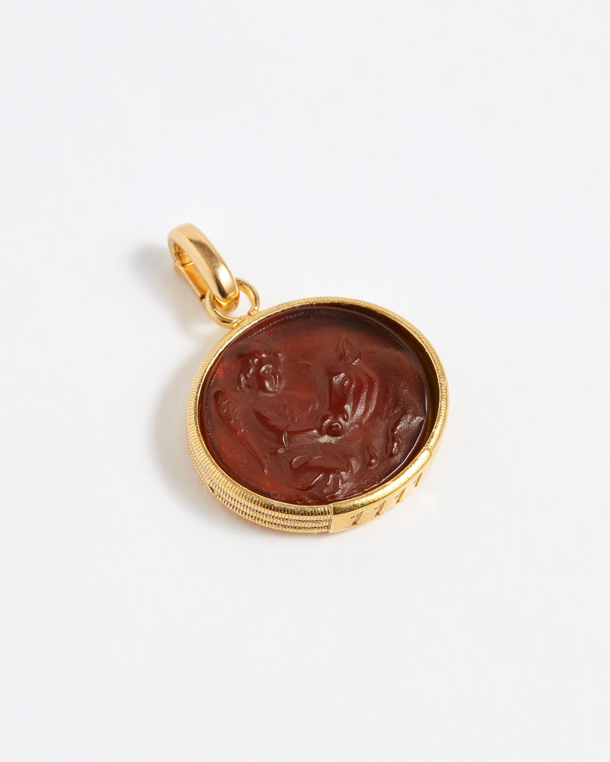 Gold pendant with a topaz circular design on a white background